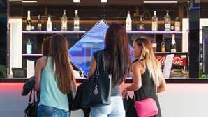 Three women standing at a bar with various bottles and a Coca-Cola sign. - FREE PARKING, FREE BREAKFAST, only 15 minutes to City Center (Budapest)