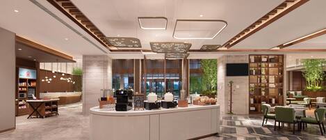 A modern hotel lobby with a central reception desk, seating area, and a large window offering a view of greenery.