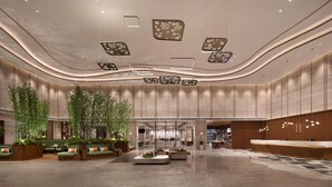 A spacious lobby with a reception desk, seating areas, and a modern ceiling design. - Hilton Garden Inn Guiyang Gui'An New Area (Guiyang)