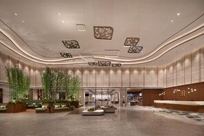 A spacious lobby with a reception desk, seating areas, and a modern ceiling design. - Hilton Garden Inn Guiyang Gui'An New Area (Guiyang)