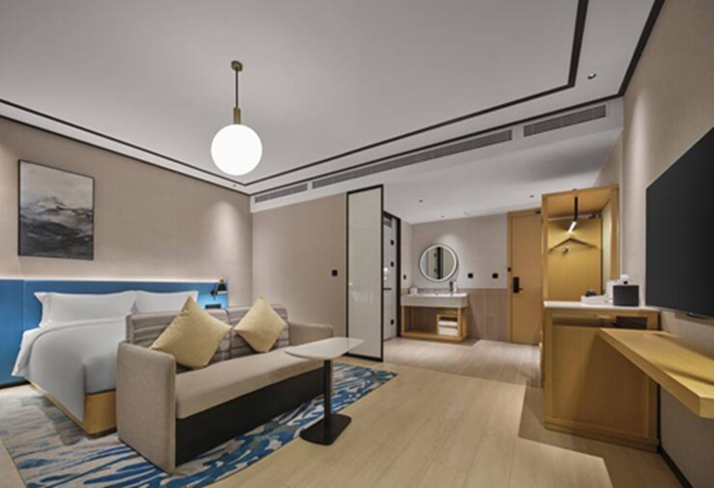 A modern hotel room with a bed, a sofa, a desk, a mirror, and a television.