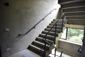 A concrete staircase with metal railings and a window at the top. - Meet Sun Moon Lake (Nantou)