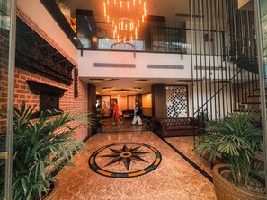 A spacious lobby with a central floor design, a staircase, and a view of the upper floor. - PRUDENTIAL HOTEL NEPAL (Kathmandu)