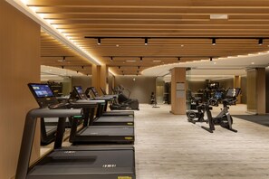 A modern gym with multiple treadmills, stationary bikes, and exercise equipment. - Waldorf Astoria Minsk (Minsk)
