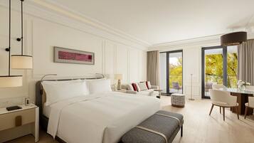 A hotel room with a large bed, bedside tables, a desk, and a view of trees through the window.