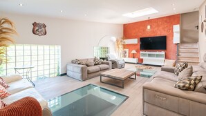 A modern living room with a sofa, coffee table, and TV.