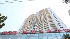 A high-rise hotel with multiple balconies and a modern facade. - Urumqi Sundan Yakaifu Theme Hotel (Urumqi)