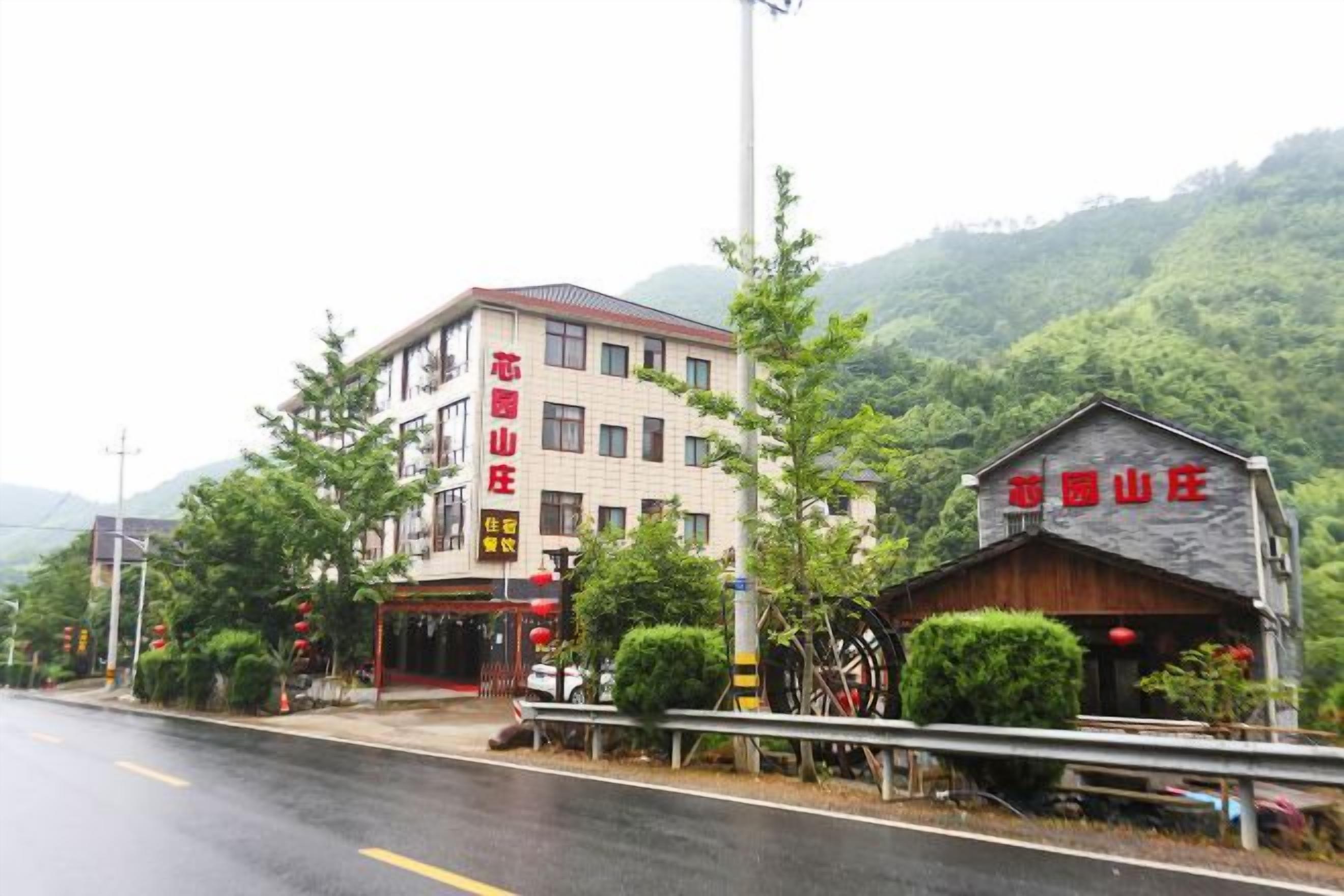 A building with a sign that reads 'HOTEL' and a smaller structure with a similar sign.