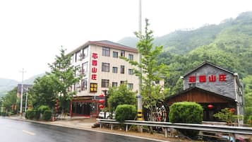 A building with a sign that reads 'HOTEL' and a smaller structure with a similar sign.