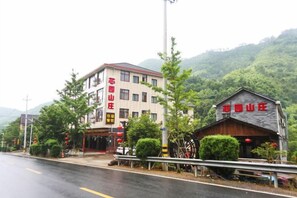 A building with a sign that reads 'HOTEL' and a smaller structure with a similar sign. - Tianmu Mountain Xinyuan Villa (Hangzhou)