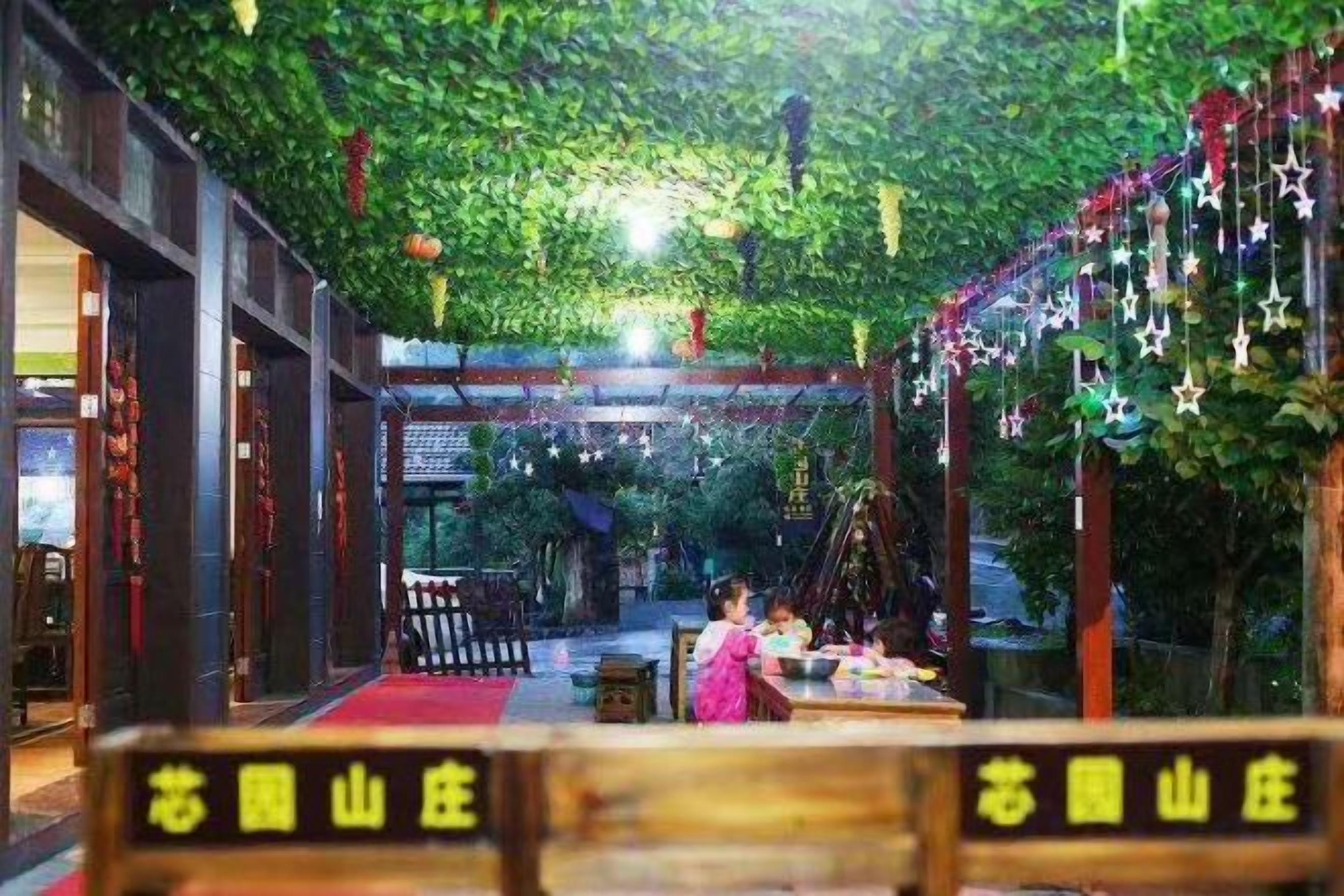 An indoor space with a wooden structure, possibly a reception or waiting area, with a red carpet and signs indicating a location.