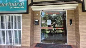 La entrada de un edificio con un letrero que indica la clínica veterinaria de la Dra. Lia Guaracibá.
