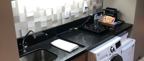 Fridge, microwave, coffee/tea maker, cookware/dishes/utensils