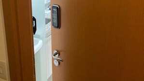 A hotel room door with a number sign indicating room 211.