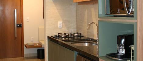 Fridge, microwave, coffee/tea maker, cookware/dishes/utensils