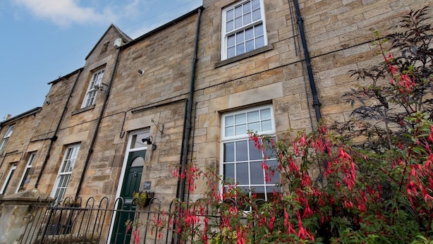 A stone building with multiple windows and a green door. - Charming Edwardian Stone Cottage Countryside Views - Pass the Keys (Stainton)