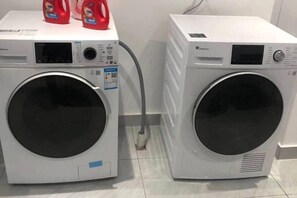 Two front-loading washing machines. - Huating Hotel (Huzhou)