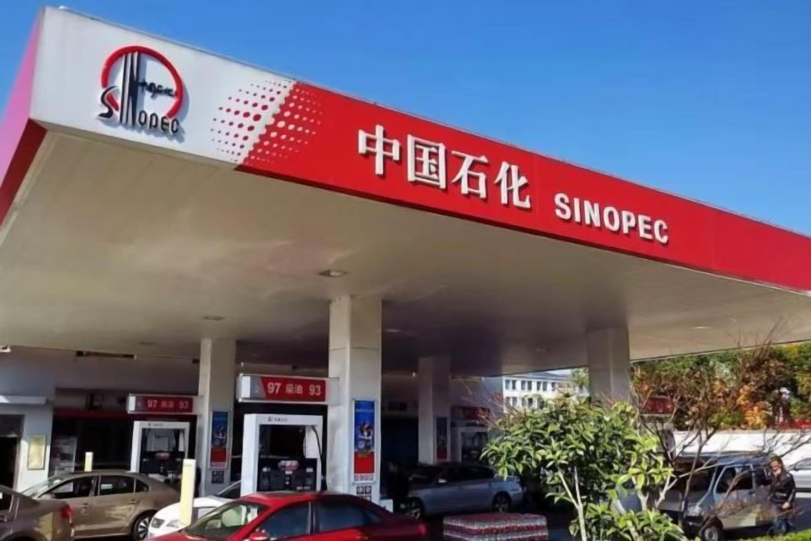 A gas station with multiple fuel pumps and a clear sky.