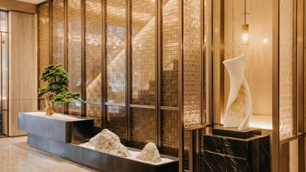 A modern interior with a reception desk, a bonsai tree, and a decorative sculpture. - Jinquan Yujing Hotel (Enping)
