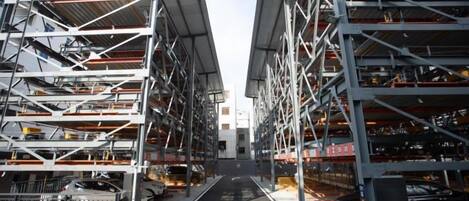 A multi-level parking garage with numerous rows of parking spaces and a central walkway.
