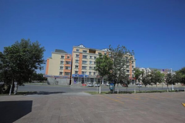 A multi-story building with a modern design, featuring a mix of balconies and windows.
