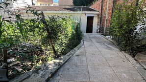 A narrow alleyway with a paved path leading to a building entrance. - Newly Renovated Gem: 15 mins train ride to Paris (Sarcelles)