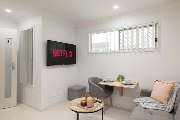 Living Area: Bright living space with comfortable seating and TV