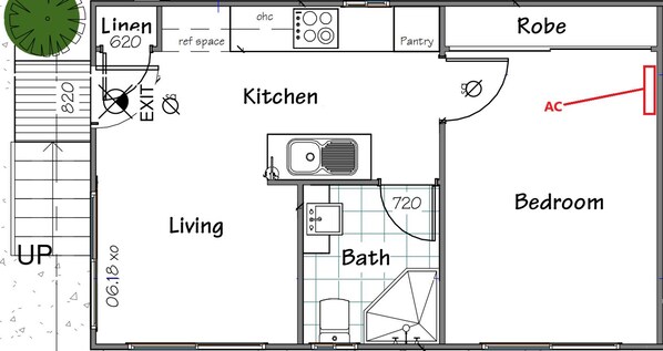 Plano de planta de una casa con habitaciones señaladas, incluyendo sala de estar, cocina, baño, dormitorio y área de lavandería.