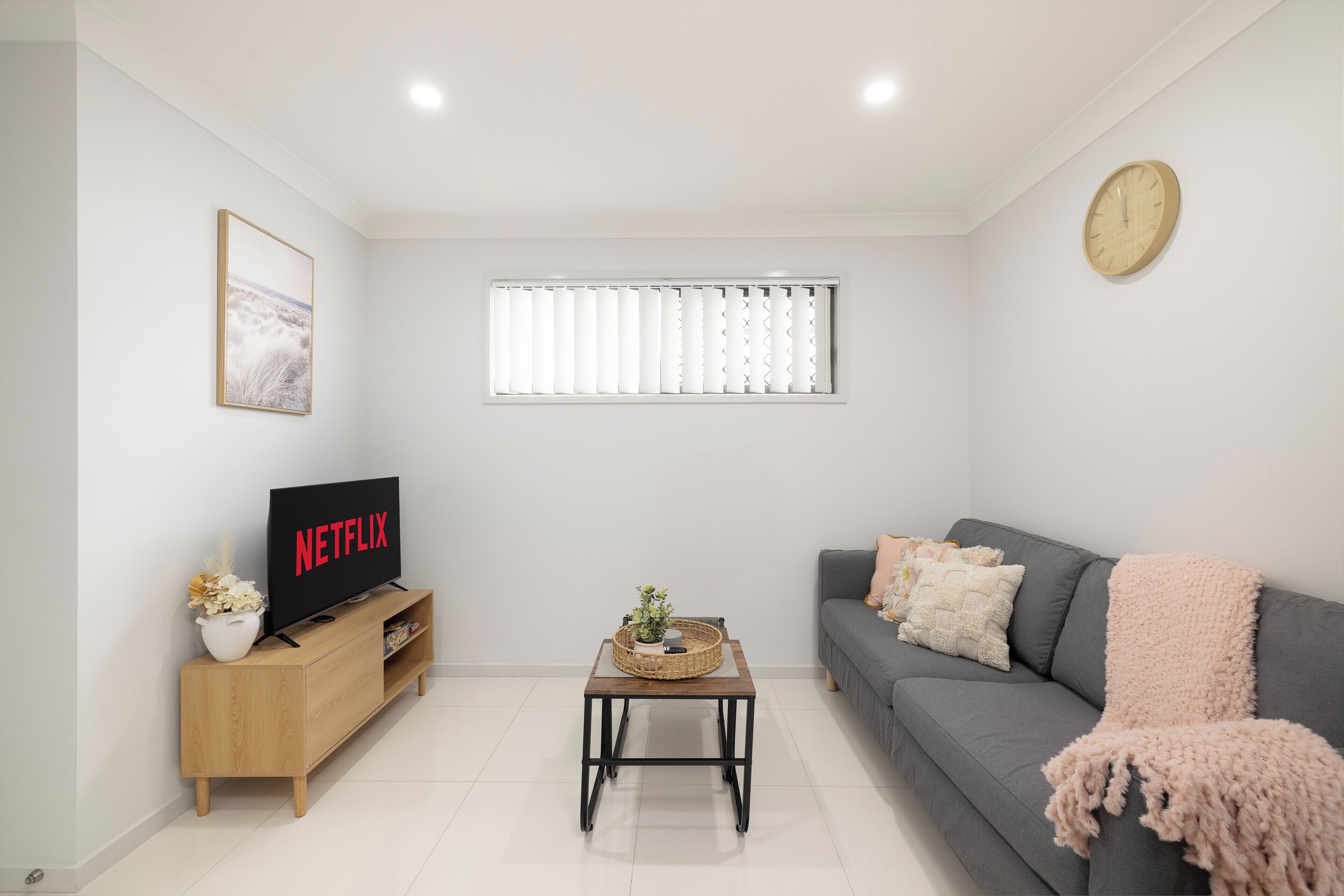 Living Area: Bright living space with comfortable seating and TV 