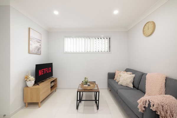 Living Area: Bright living space with comfortable seating and TV