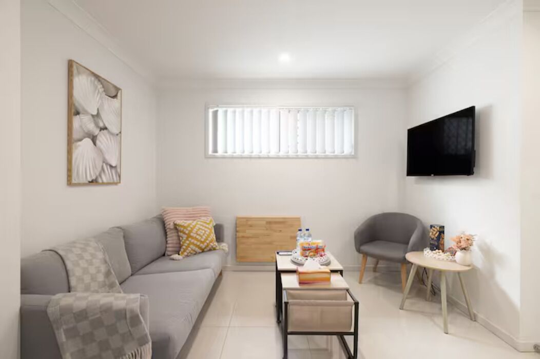 Living Area: Bright living space with comfortable seating and TV 