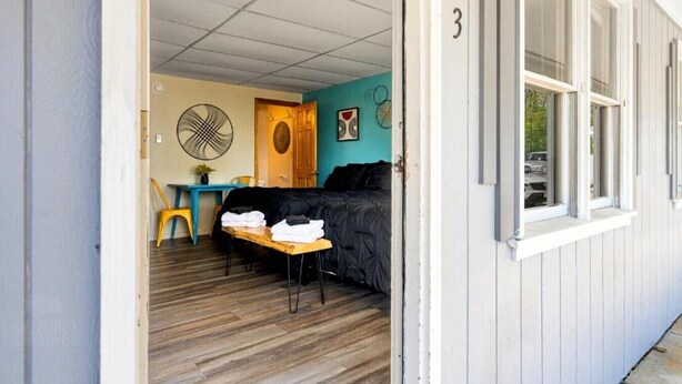 A room with a bed, a desk, and a chair.