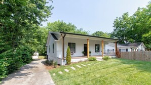 A single-story mobile home with a porch, a small front yard, and a wooden fence. - Luxe 4-Bed Retreat w/ Game Room & Deck – 10 Min to Downtown (Nashville)
