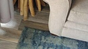 A room with a wooden stool, a white seahorse sculpture, a beige sofa, and a blue rug. - Isle B Back Cozy 1-bedroom condo with WiFi, AC in amazing Galveston (Galveston)