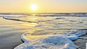 A beach scene with the sun setting over the ocean. - EndlessWaves Oceanfront Gulf View Resort 2 Pools (Galveston)