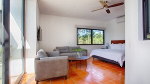 A modern bedroom with a bed, a sofa, and a coffee table.