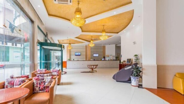 A hotel lobby with leather seating, a reception desk, and a large window. - GreenTree Inn Kunshan Shimao Square Hotel (Kunshan)