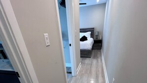 A narrow hallway with wooden flooring and white walls. - Center City Philadelphia rooftop (Philadelphia)