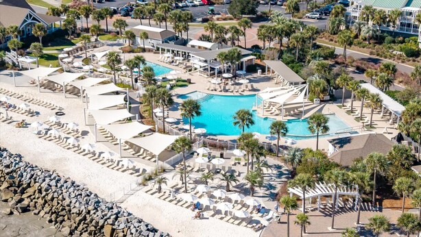 A resort with multiple swimming pools, sun loungers, and palm trees. - Luxury Villa, Club Access, Beach, Pet-Friendly (Seabrook Island)