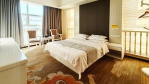 A hotel room with a bed, a desk, a chair, a balcony with a railing, and a window with curtains. - Wanjia Hotel (Lincang)