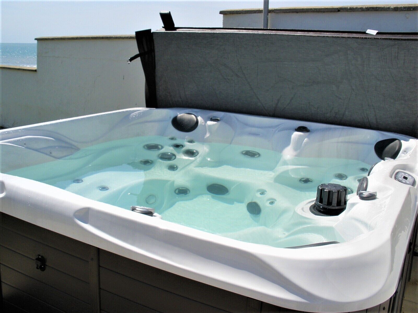 A hot tub with a view of the sea.