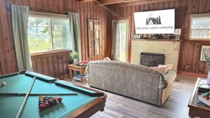 A cozy room with a pool table, a sofa, and a fireplace. - Lake Views! Little Bell Bungalow Charmer, Backyard, Game Room, Foosball (Forsyth)