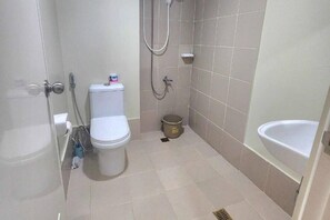 A small bathroom with a toilet, a shower, and a sink. - 1 Bed Flat - Pool - Parking - Wifi (Baguio)