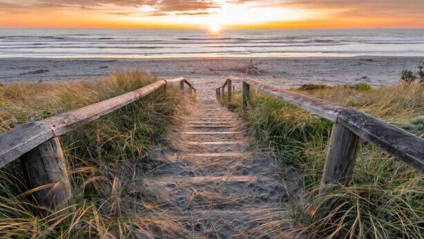 A wooden pathway leading to a beach at sunset. - Beachside Townhouse - New Brighton (Christchurch)