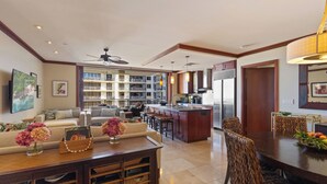A spacious living area with a sofa set, dining table, and kitchen in the background. - Highly Rated 7th Floor End Unit with Amazing Lanai Views. Book Ahead & Save!! (Kapolei)