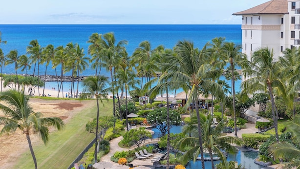 A resort with a pool, palm trees, and a view of the ocean. - Highly Rated 7th Floor End Unit with Amazing Lanai Views. Book Ahead & Save!! (Kapolei)