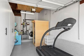 A room with a treadmill, a washing machine, and a heater. - Sunnyside Resort Spa, Beach, Zoo, Arcade (La Mesa)
