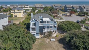 A coastal residential area with houses featuring balconies and a view of the ocean. - 2616 - Bay to Breakers - Semi-Oceanfront Retreat w/ Pool & Hot Tub (Duck)
