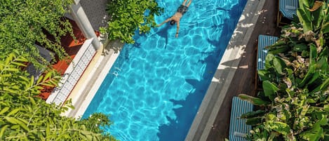 Outdoor pool, open 9:00 AM to 9:00 PM, pool umbrellas, pool loungers