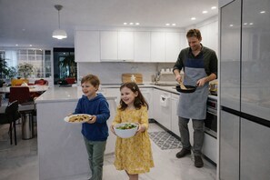 A modern kitchen with white cabinets, a central island, and stainless steel appliances. - Maison de Pepperoni Cheongdam N.2 PH, COEX, Romantic suite in Gangnam (Seoul)